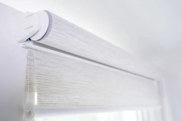 Close up mechanism of tnaninny roller blinds indoors. Duo window roller system day and night