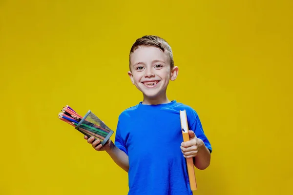 Smiling Happy Schooler Blue Shirt Holding Multicolored Pencils Book Yellow — Fotografia de Stock