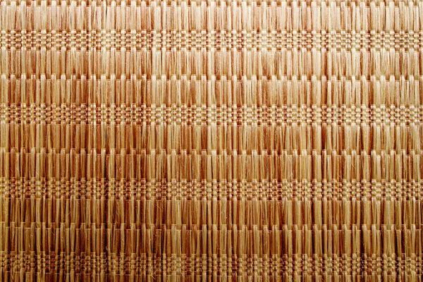 Wicker background made of natural straw. Full frame of densely woven straw pattern. Natural, natural background.