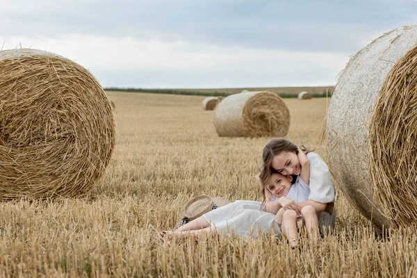 Young Mother Her Son Hugging Straw Bales Field Happy Family — стоковое фото
