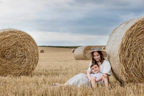 Young Mother Her Son Hugging Straw Bales Field Happy Family — Foto de Stock