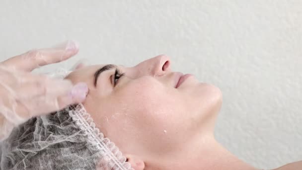 Female Cosmetologist Applies Cream Client Face Massaging Movements Moisturizing Cleansing — Stock Video