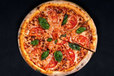 Delicious fragrant pizza with mozzarella, tomatoes and basil with tomato sauce - Margherita.
