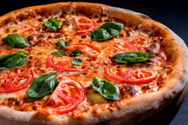 Delicious fragrant pizza with mozzarella, tomatoes and basil with tomato sauce - Margherita.