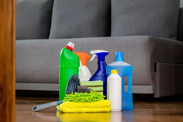 Household cleaning products and rags on floor. Chemical liquids for cleaning. Maintaining cleanliness.