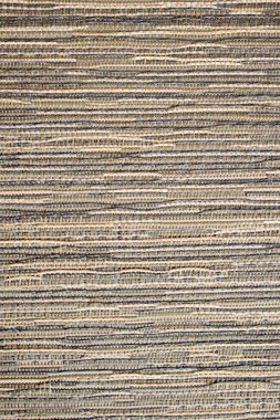 Textile pastel background with abstract weaving of threads. Fabric tufted multi-colored background.