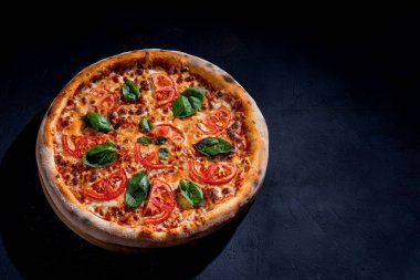 Delicious fragrant pizza with mozzarella, tomatoes and basil with tomato sauce - Margherita. Top view.