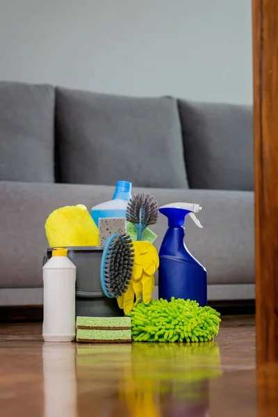 Household cleaning products and rags with reflection in the floor. Chemical liquids for cleaning. Maintaining cleanliness.