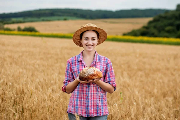 Female Farmer Straw Hat Checkered Shirt Holds Fragrant Bread Her — Zdjęcie stockowe
