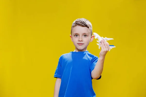 Little Boy Blue Shirt Holds Toy White Plane Plays Yellow — Fotografia de Stock