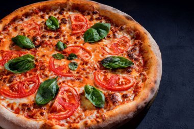 Delicious fragrant pizza with mozzarella, tomatoes and basil with tomato sauce - Margherita.