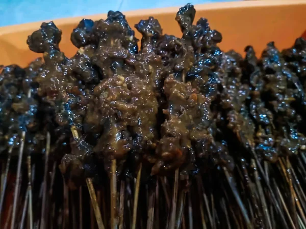 Closeup view of snail satay, Indonesian traditional food
