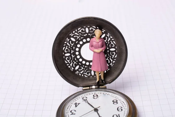 Mechanical retro pocket watch  and a woman figurine