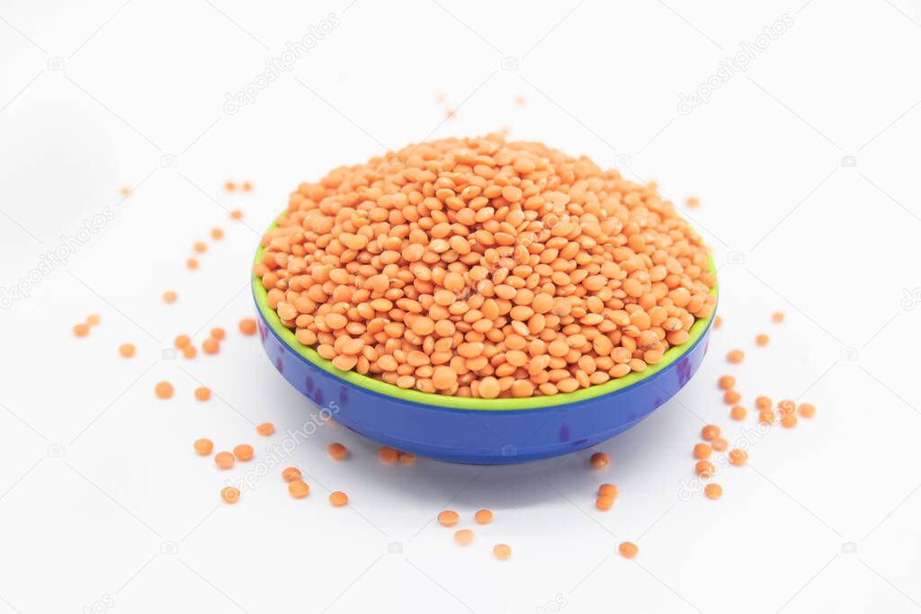 Red lentils pile isolated on white background, also known as dry orange lentil grains, heap of dal, raw daal, dhal, masoor dhal
