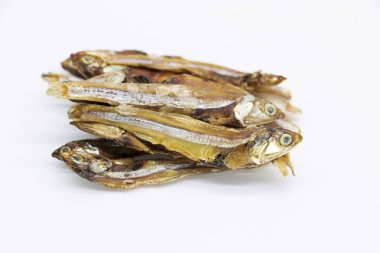 Dried Small fish or Salted anchovy fishes over on white background, selective focus