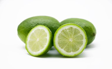 Limonları beyaz arkaplanda tek parça halinde dilimle