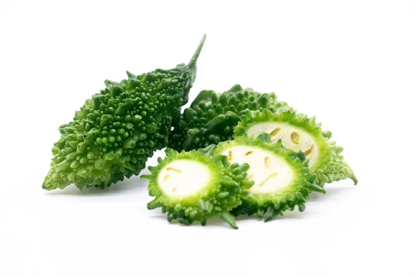 whole bitter melon or bitter gourd slices isolated on white background, selective focus