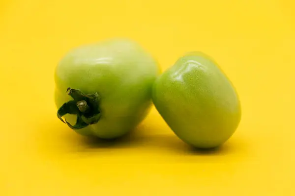 Two Green Tomato Isolated Yellow Background — Stock Photo, Image