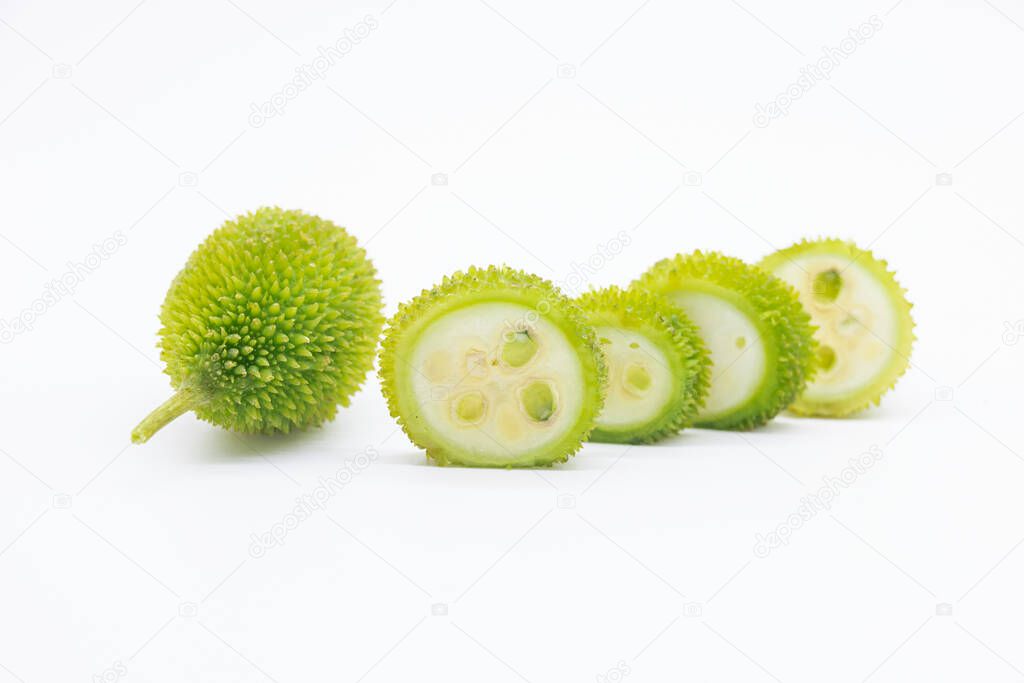 whole and slices spiny gourd isolated on white background