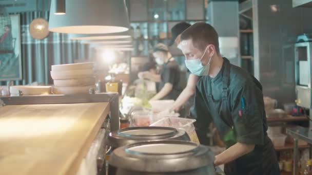Chefs estão usando máscaras enquanto cozinham refeições — Vídeo de Stock
