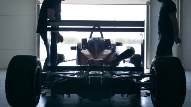 Racing car is getting checked by two mechanics — Stock Video