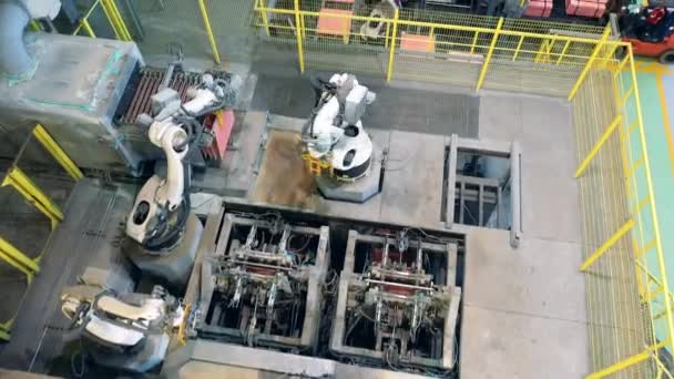 Top view of modern robotic machines working with copper plates — Stock Video