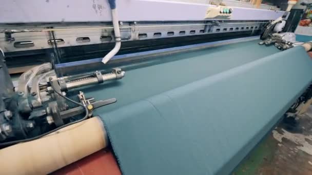 Woven fabric is getting released by an industrial machine — Stock Video