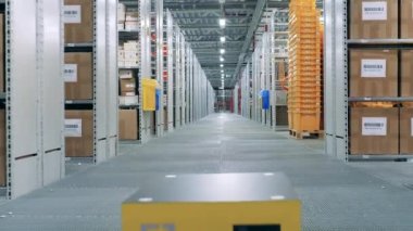 Endüstriyel bir robotun geçtiği depo koridoru.