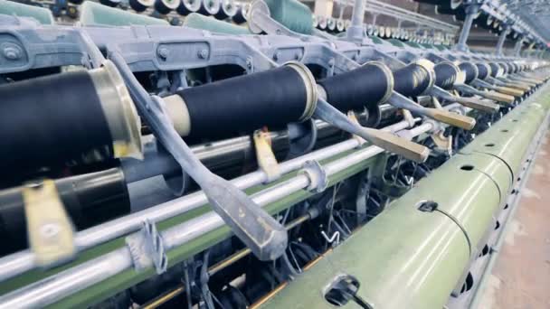 Sewing spools are revolving in the textile machinery — Stock Video