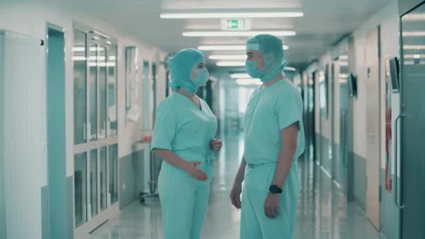 Dva chirurgové mluví na chodbě lékařského oddělení. — Stock video