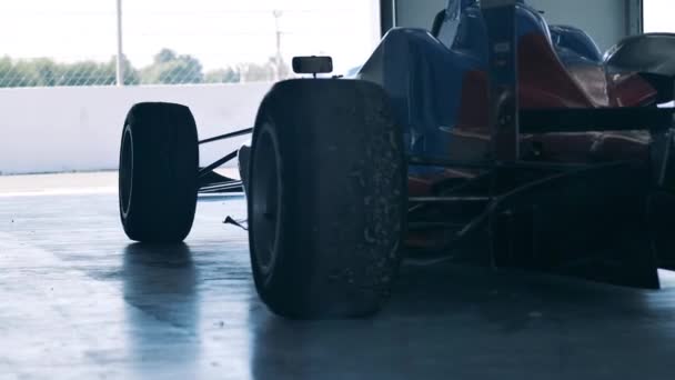 Used racing car parked in a garage unit — Stock Video