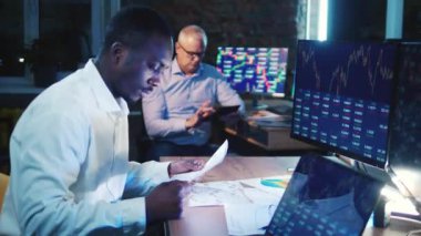 Businessman trader, broker concept. Two stockbrokers are monitoring diagrams and graphs