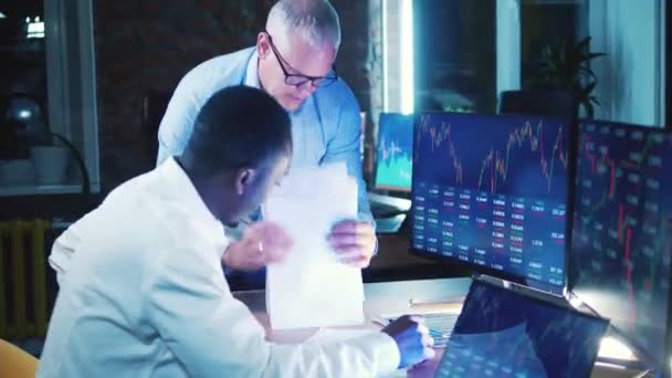 Male stockbrokers are analyzing reports with stock information — Wideo stockowe