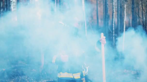 Fireman is talking over the radio in the smoldering woods — Stockvideo