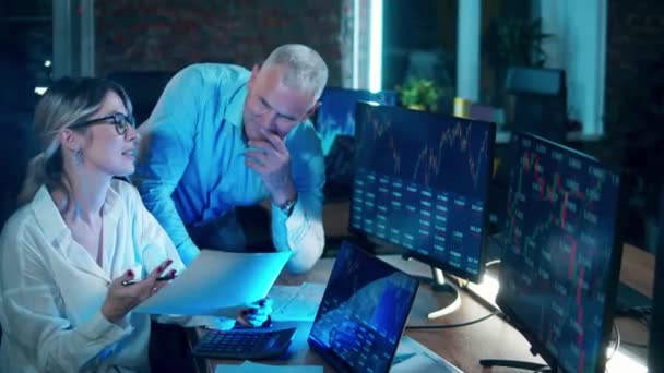 Business, finance, market trading concept. Two stockbrokers are observing and discussing data reports — Stock Video