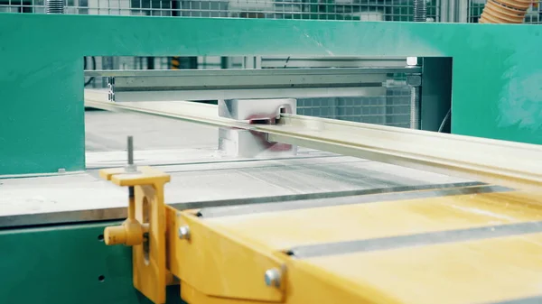Factory press with a fiberglass frame moving through it Fotos de stock