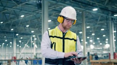 Male specialist is managing working process at the factory