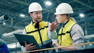 Factory specialists are discussing production process