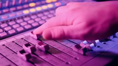 Recording studio with a mixing console being regulated