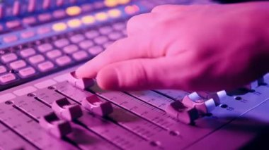 Recording studio with a mixing console being regulated. 4K