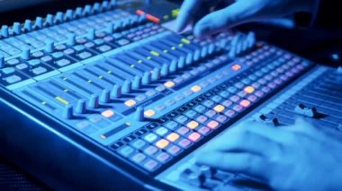 A person is operating a mixing console. 4K