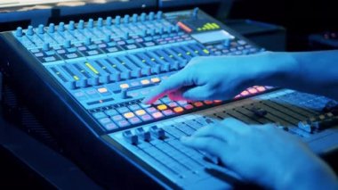 Mixing console is being operated in a recording studio. 4K