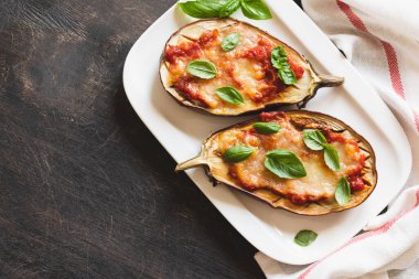 baked eggplant with tomatoes and mozzarella and basil.