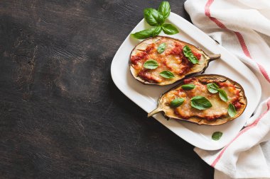 baked eggplant with tomatoes and mozzarella and basil.