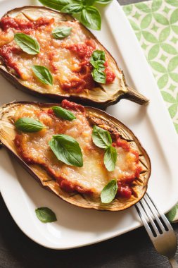 baked eggplant with tomatoes and mozzarella and basil.