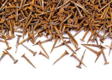 Rusty square cut carpentry nails on white