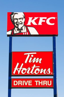 Stewiacke, Canada - February 23, 2016: KFC or Kentucky Fried Chicken is a fast food restaurant chain specializing in fried chicken. Tim Hortons is a Canadian chain known for its coffee and doughnuts.