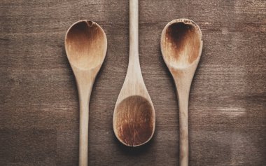 Wooden kitchen spoons on table top
