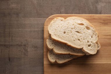 Sliced rye bread on cutting board with copy space