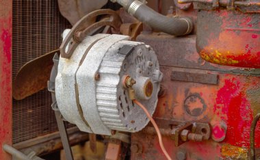 Old and weathered alternator and engine